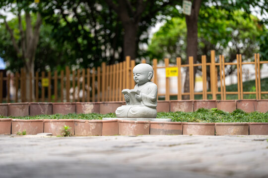 Stone Jizo statue reading book
