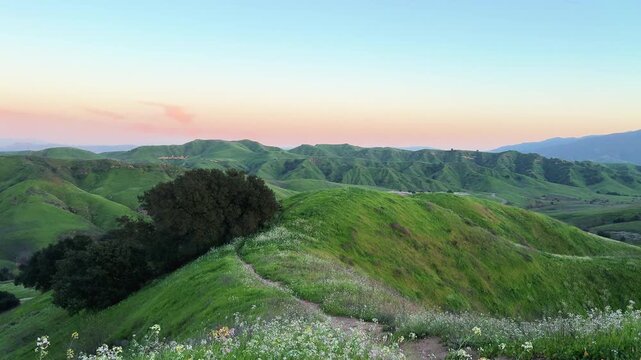 Scenic view of rolling green hills and trail at sunset in Chino Hills State Park, nature backgrounds, California landscapes and outdoor lifestyle.