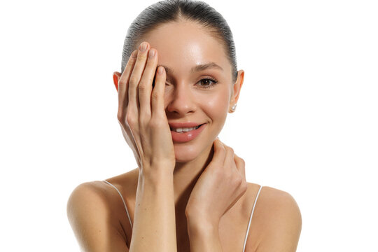 Young woman face with closed eye clean skin on white background
