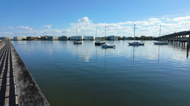 Slow pan across ICW from bridge in Lake Worth Beach Florida to Snook Island boardwalk.