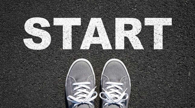Starting point with sneakers on asphalt road