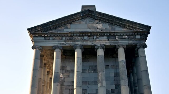 Grand stone Garni temple with tall columns and triangular roof