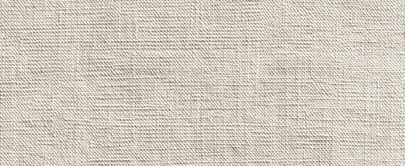Fototapeta premium Close-up of a textured, woven, light beige fabric with a matte finish