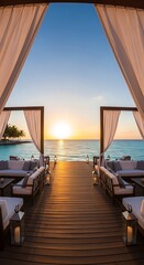 Fototapeta premium Tropical resort lounge area with white drapes and seating on a wooden pier at sunset over the ocean, serene vacation destination