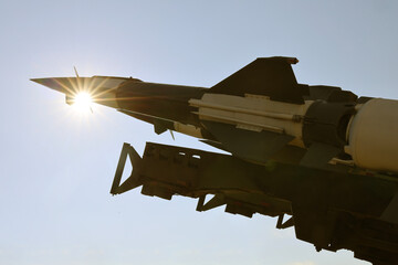 Obraz premium sunrays sky background. weapons, military air defence complex. missile. atomic nuclear ballistic rocket with one rocket cruise missiles