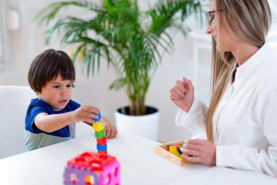 Child psychology, little boy making tower with blocks