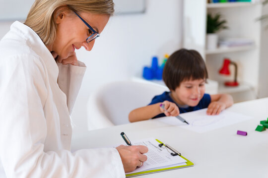 Child psychology, little boy talking to psychologist