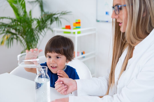 Child psychology, toddler doing tests with water and glasses