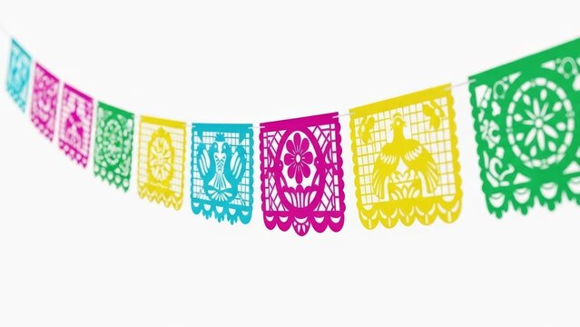 Colorful papels picados strung against a white background, traditional festive decoration