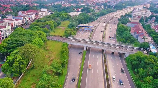 Aerial Drone View of Toll Gate and Highway Interchange in Urban Indonesia with Residential Area