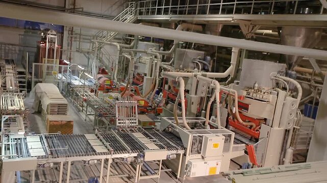 A production or conveyor line at a ceramic and porcelain tile factory. Manufacturing process of ceramic tiles.