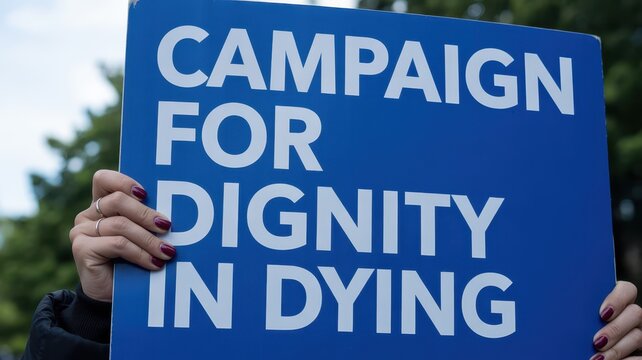 Person holding a blue campaign for dignity in dying protest sign