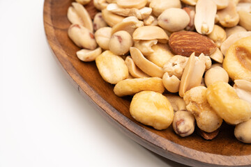 Fototapeta premium Mixed nuts and beans snack on wooden dish closeup view