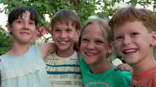 Cheerful Cmpany of Friends. Four friends hugging and laughing together having fun on the background of trees