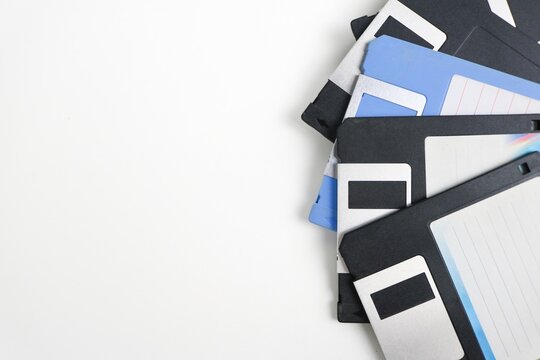 Close-up of stacked old floppy disks isolated on white background