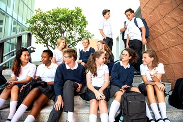 Students socializing on school steps.