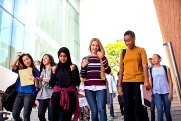 Fototapeta premium Diverse students walking together outdoors.