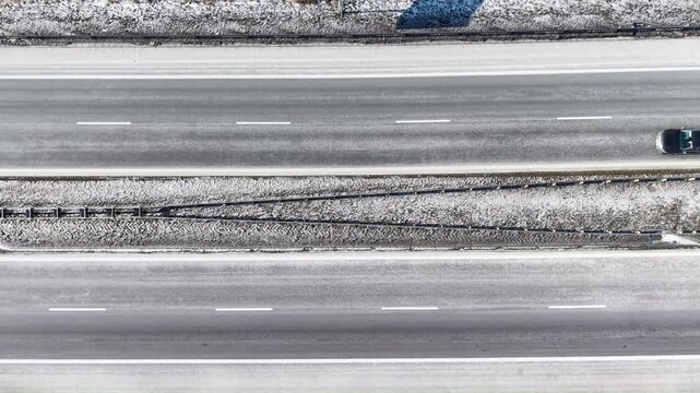 Top down view of S3 expressway covered in snow with passing traffic near Gorz&oacute;w Wielkopolski. Poland
