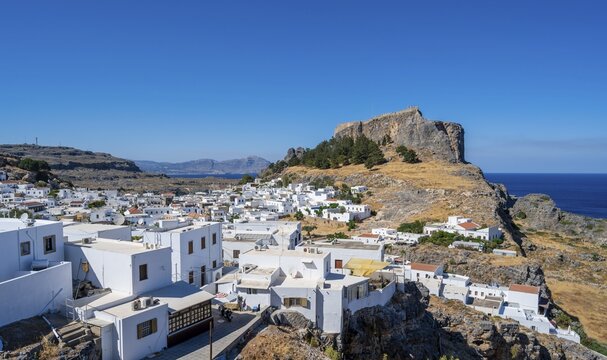 Town of Lindos with white houses, in the back Acropolis of Lindos, Lindos, Rhodes, Dodecanese, Greece