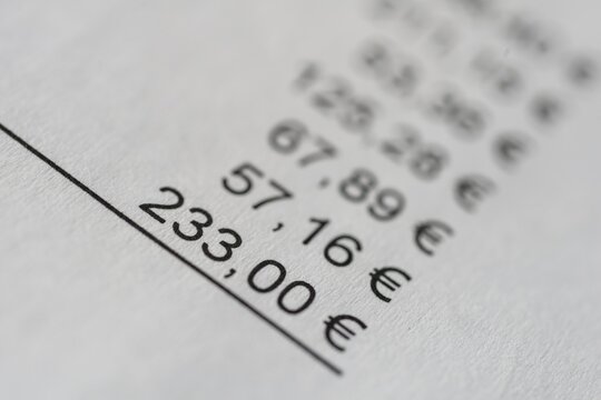 Sum of an invoice on paper, numbers and prices in euro