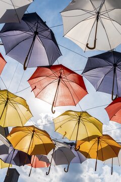 Many colorful umbrellas, sunshades, hanging in the air, sunshine, Imst, Tyrol, Austria
