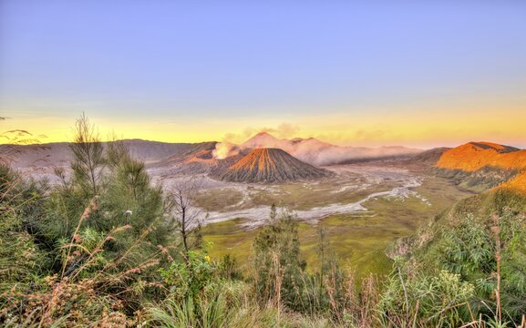 Sunrise, smoking volcano Mount Bromo, Mt. Batok at front, Mt. Kursi at back, Mt. Gunung Semeru, Bromo Tengger Semeru National Park, Java, Indonesia