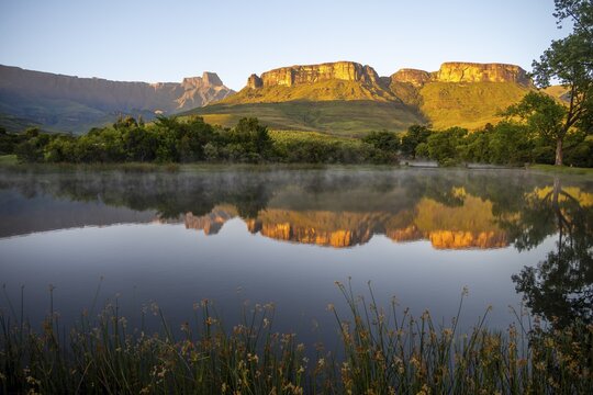 Sunrise, amphitheatre with reflection in the lake, Royal Natal National Park, Drakensberg Mountains south, Kwa Zulu Natal, South Africa