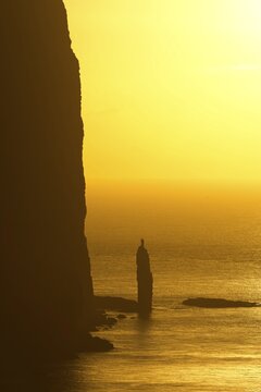 Kellingin sea stack, petrified troll according to legend, at sunset, Ei&eth;i, Eysturoy, Faroe Islands, Denmark