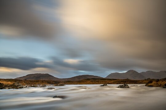 River Ba with mountain peaks in the background and dramatic clouds, Glen Coe, Rannoch Moor, west Highlands, Scotland, United Kingdom