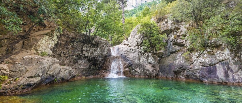 Upper course of the river Solenzara, large churn hole with waterfall in the forest, Corsica, France