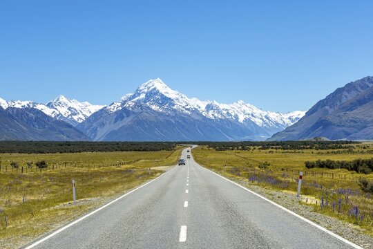 Country road overlooking snow-capped Mount Cook National Park, Southern Alps, Canterbury, South Island, New Zealand