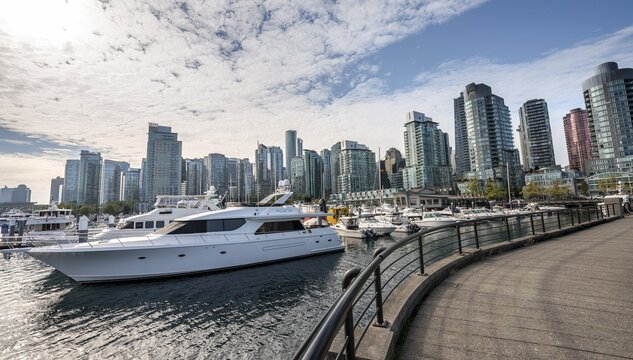 Boats in the marina, high-rise buildings on the promenade, Coal Harbour, Vancouver, British Columbia, Canada