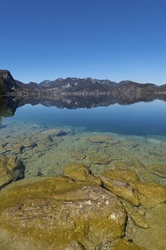 Lake Wolfgang with a reflection of the surrounding mountains, near St. Gilgen, Salzkammergut, Salzburger Land, Ober&ouml;sterreich, Austria