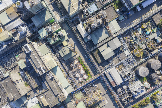 Aerial view of a chemical fiber plant showing a complex network of industrial pipes, storage tanks, and cooling towers in Taiwan.