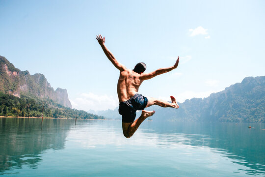 Joyful leap into serene waters