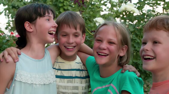 Merry Company on Vacation. Four friends hugging and laughing together having fun on the background of trees