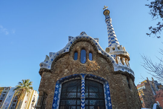 Park Guell,Barcelona,Spain,Architectural structure with mosaic details and tiled spire under clear blue sky