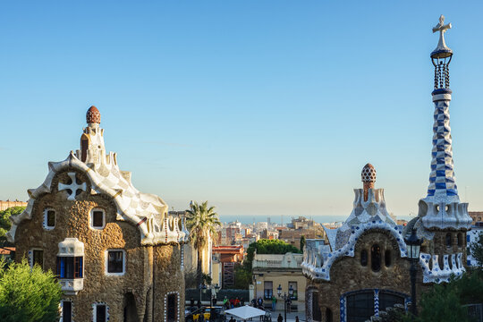 Park Guell,Barcelona,Spain,Architectural structures in a park with distinctive ornate designs and tiled spires under a clear sky