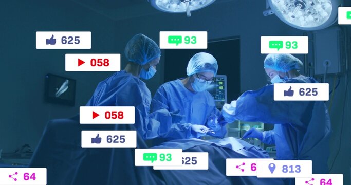 Operating team performing procedure on draped patient in OR, wearing blue gowns with social icons