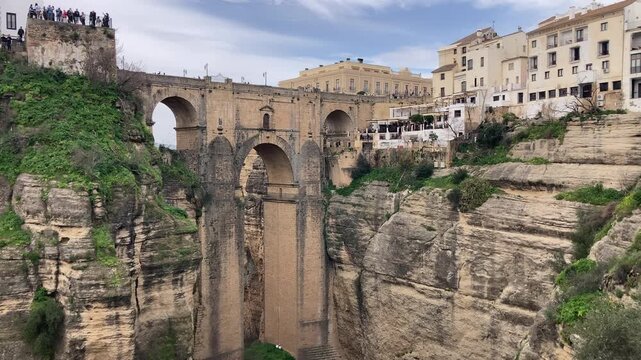 Puente Nuevo dramatic bridge spanning a deep limestone gorge creating iconic architectural landmark in Ronda, Spain.