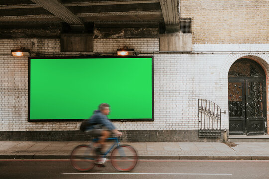Urban billboard with cyclist motion, suitable as mockup
