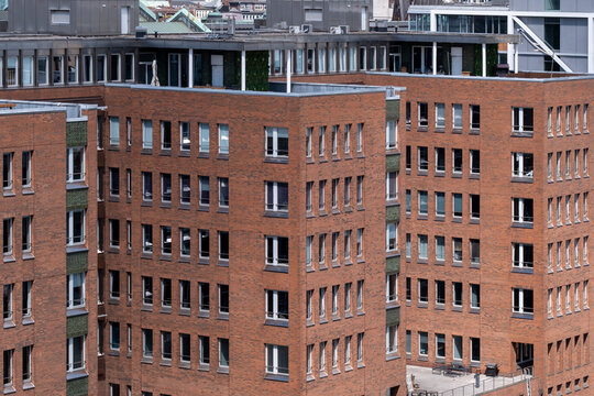 Urban corporate brick architecture of offices and buildings facade with windows and repeating pattern highlighting industry character in city redevelopment