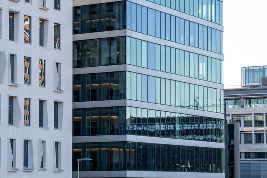 Modern urban corporate offices and buildings facade with glass windows showing crisp architecture pattern and clean symmetry in contemporary exterior design