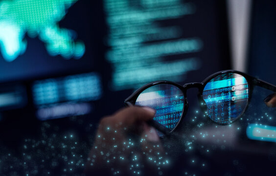 Digital code reflected in glasses