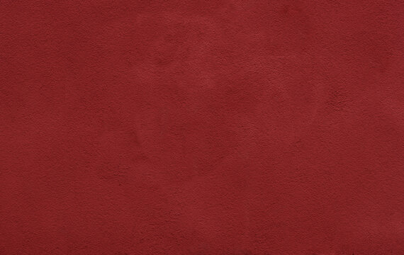 Deep red suede texture fills the frame