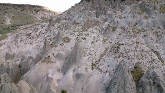 Top Down Aerial Shot of Volcanic Rock Formations in Selime, A unique bird's-eye view looking straight down at the complex textures and patterns of the volcanic tuff rock formations.