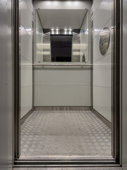 Fototapeta premium Interior View of a Modern Elevator with Sleek Design, Reflective Surfaces, and Illuminated Environment Capturing the Essence of Contemporary Architecture