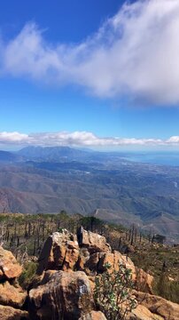 Sweeping mountain panorama revealing the sparkling Mediterranean Sea, Estepona and distant Gibraltar beneath open skies from Sierra Bermeja in Spain.