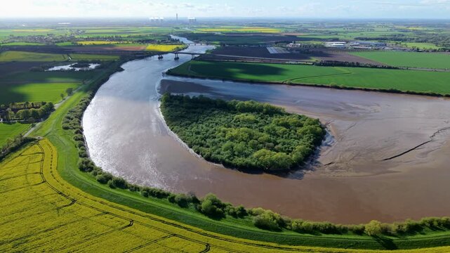 Aerial drone view of Howden Island and the River Ouse, showcasing a unique forested landform and green landscape near Goole, UK.
