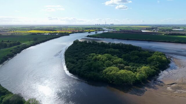 Aerial drone view of Howden Island and the River Ouse, showcasing a unique forested landform and green landscape near Goole, UK.